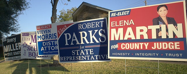 Campaign yard signs staked in a lawn